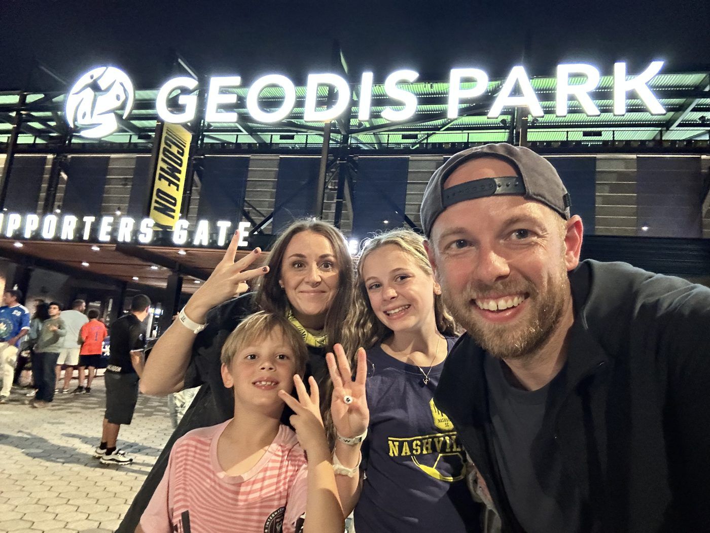 Aaron with his wife and kids outside GEODIS Park