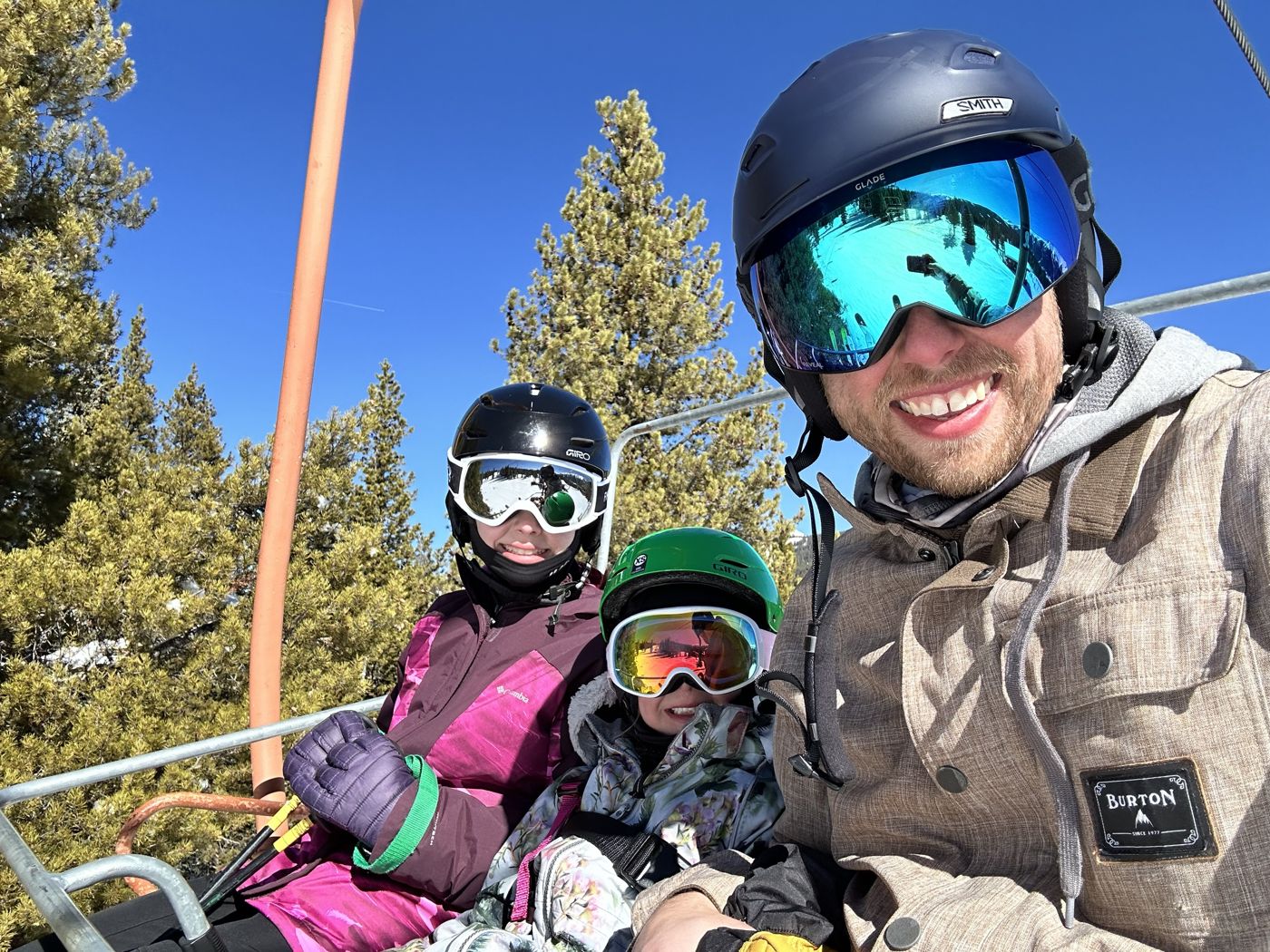 Aaron on a ski lift with two of his kids