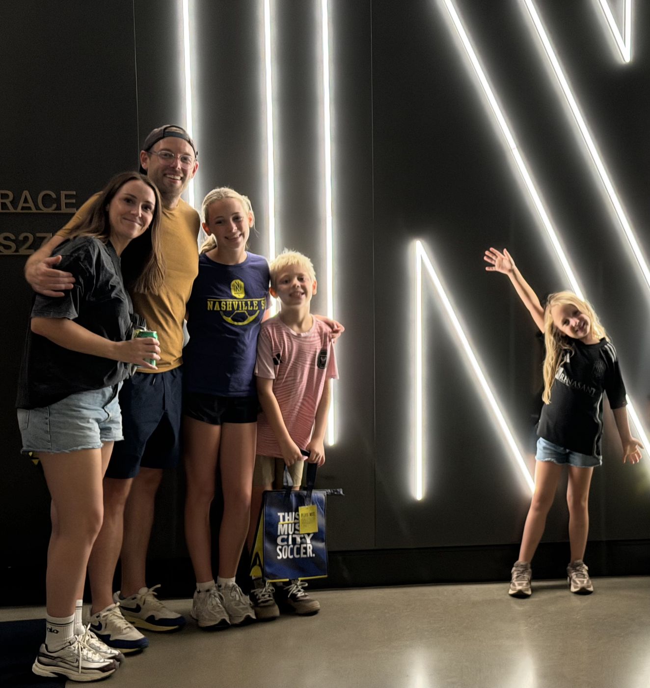 Aaron with his wife and three kids at a Nashville SC match