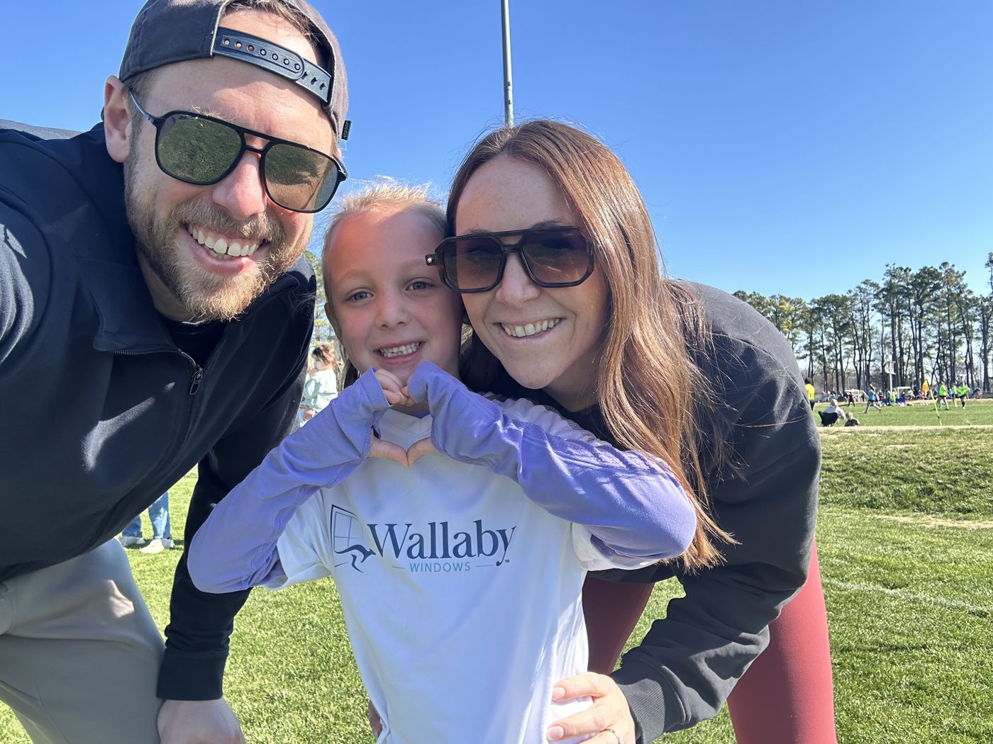Aaron, his wife and daughter on the sideline of a youth soccer game