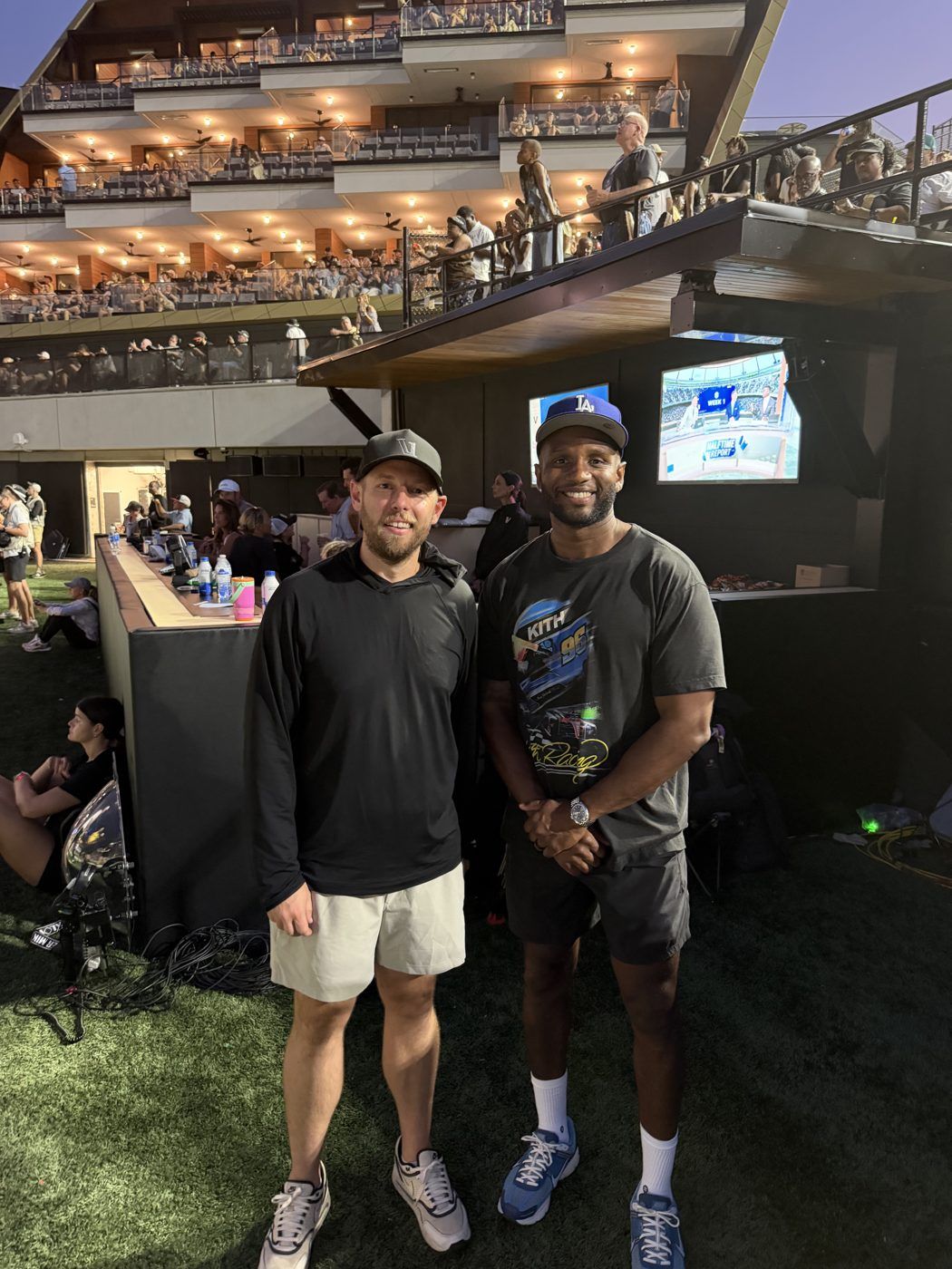 Aaron standing with his friend Josh Henley at an outdoor event